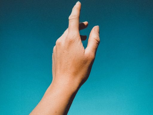 persons left hand doing thumbs up sign